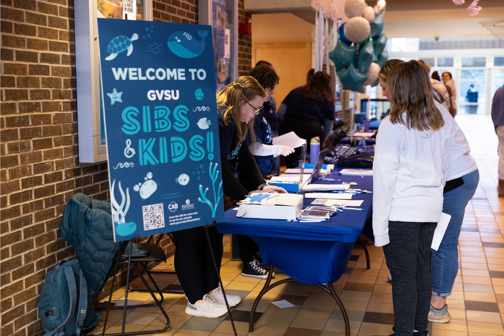 Sibs and kids weekend 2024 check-in table